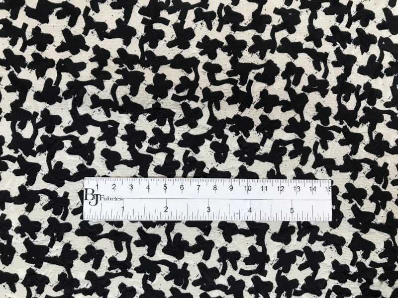 Silk and wool brocade with deconstructed houndstooth pattern with ruler for scale