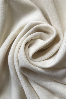 cream polyester jersey is in a swirl to show texture and weight