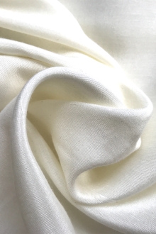 ivory rayon sateen is in a swirl to show sheen and weight