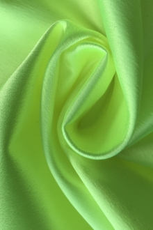 neon green stretch satin in a swirl